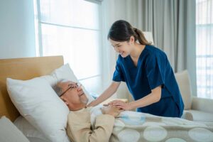 A senior and their family discuss care needs with a professional at a cozy, well-lit table.
