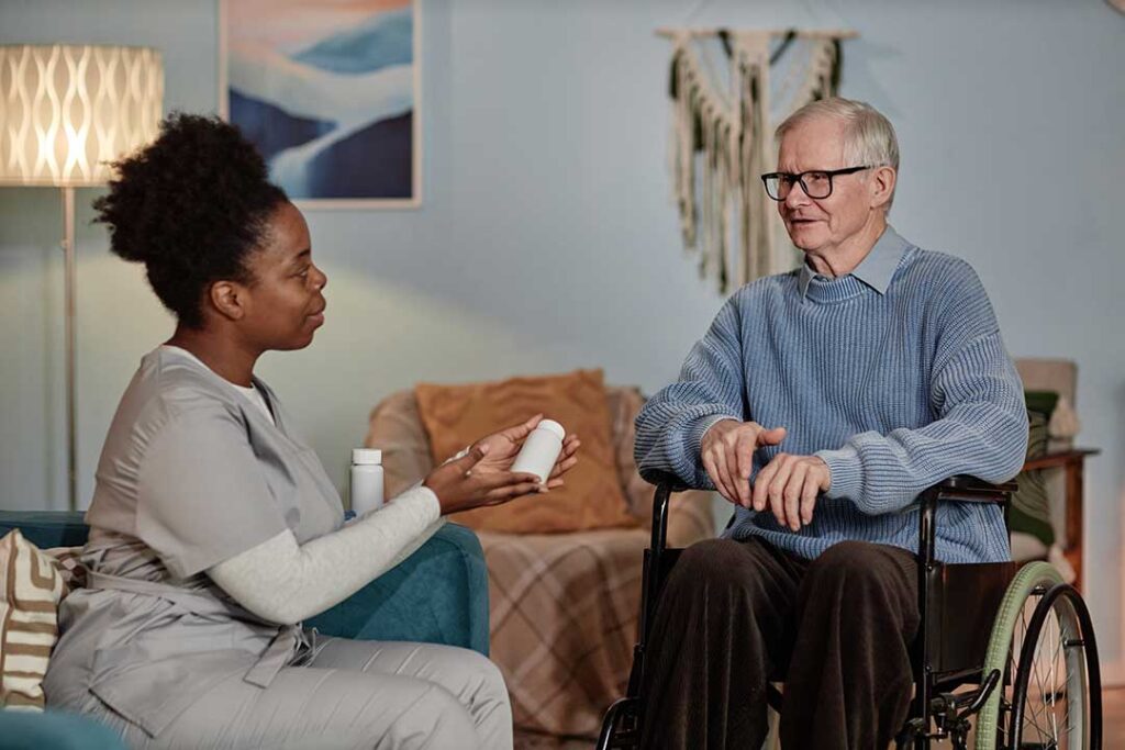 Older adults walking with walkers and canes in a bright, accessible hallway with supportive handrails.